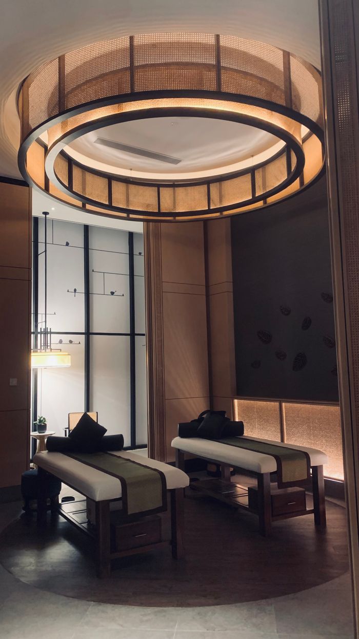 Elegant spa treatment room showcasing modern interior design with ambient lighting.