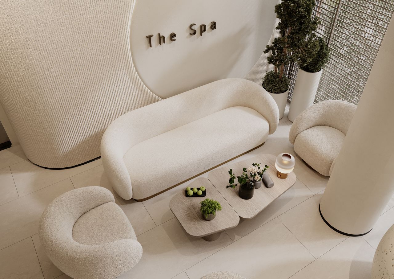 Modern spa waiting area with cozy beige furniture and decorative plants.