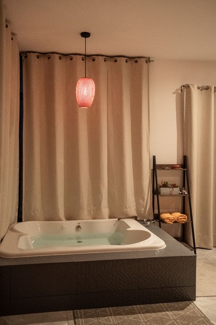 Elegant bathroom featuring a modern bathtub, warm lighting, and sophisticated interior design.