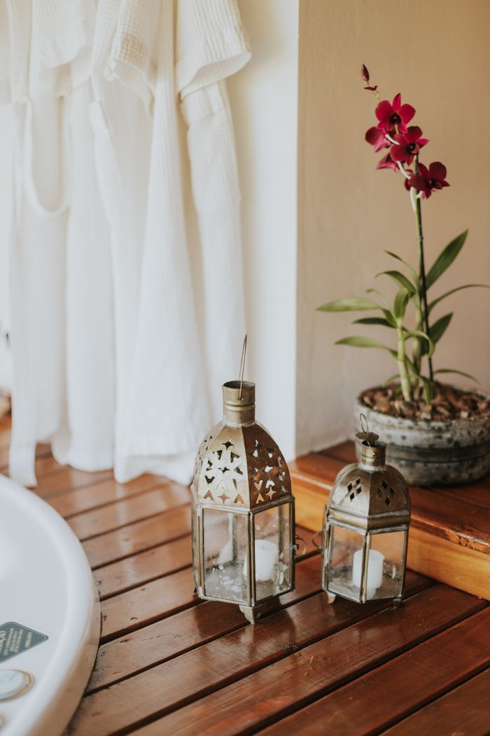 Elegant spa scene featuring lanterns and a vibrant orchid for a tranquil atmosphere.